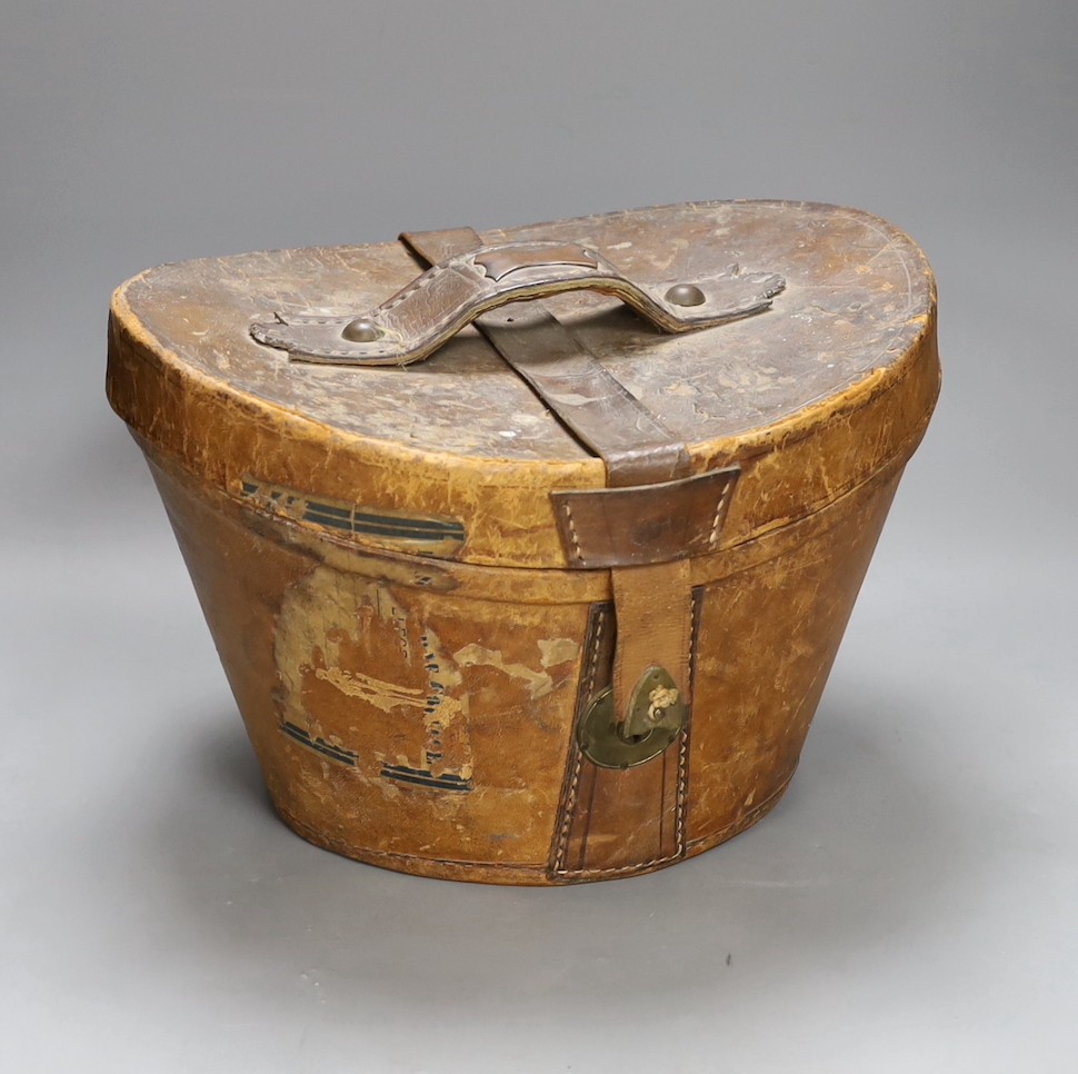 A leather cased Cuthbertson top hat, 19.5x15.5cm